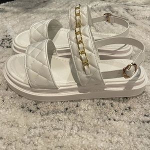 White quilted sandals with gold chain detail